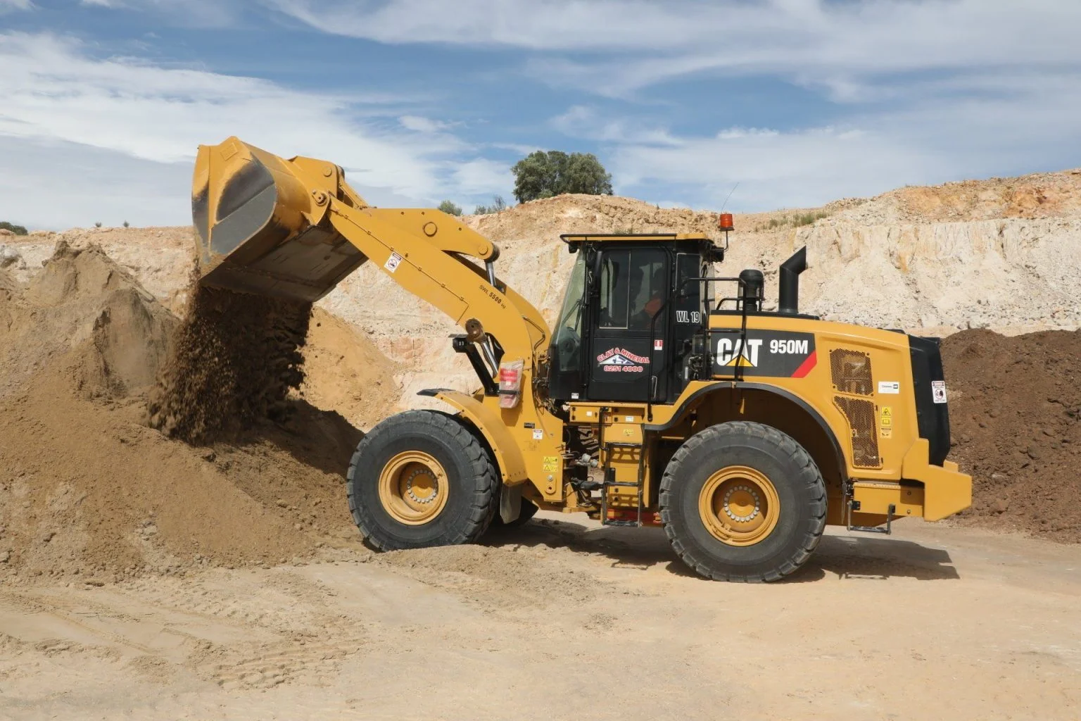 clay and mineral front end loader moving sand